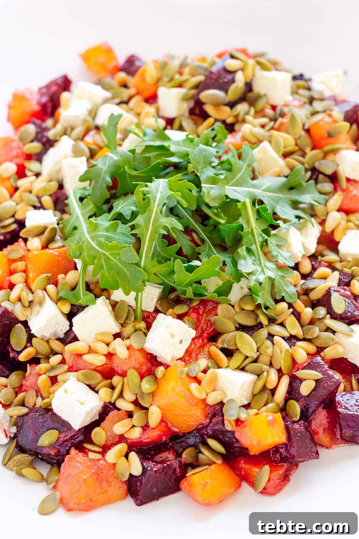 41 Fresh Fall Salad Recipes to Try This Season 7 A pile of cubed beets, pumpkin, feta, pumpkin seeds and pine nuts, topped with arugula.