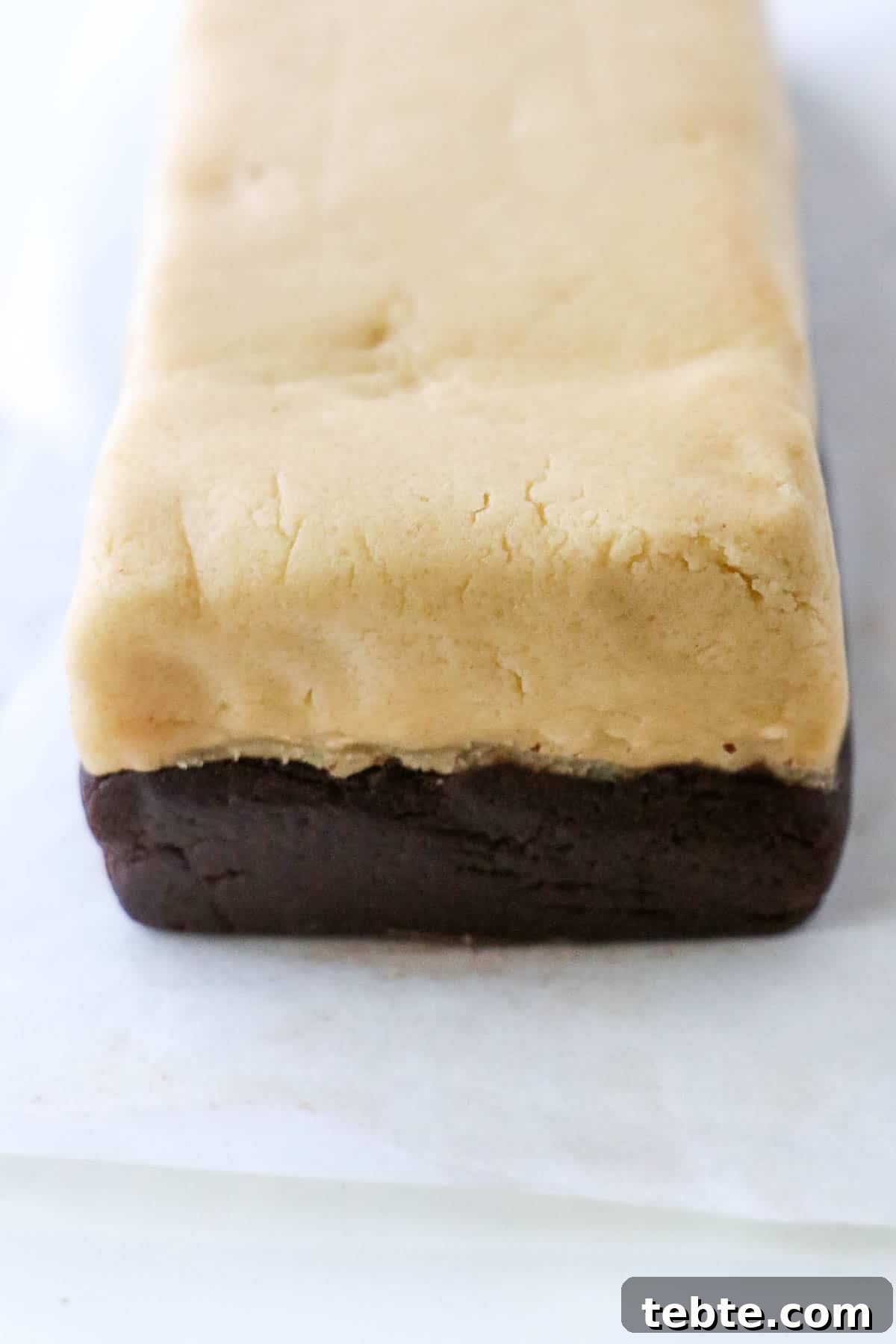 Two rectangle layers of cookies dough on top of each other.