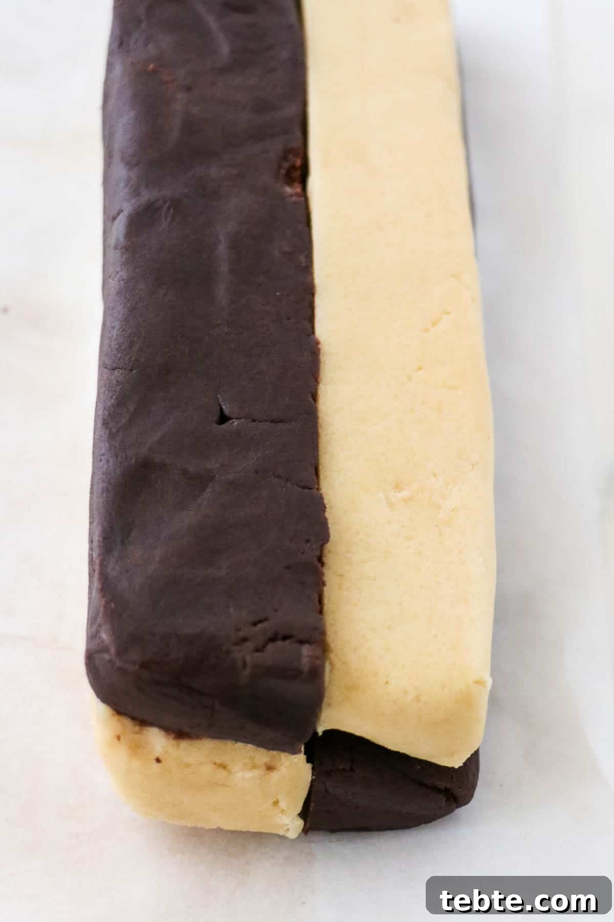 Alternating layers of chocolate and vanilla cookie dough in a log shape.