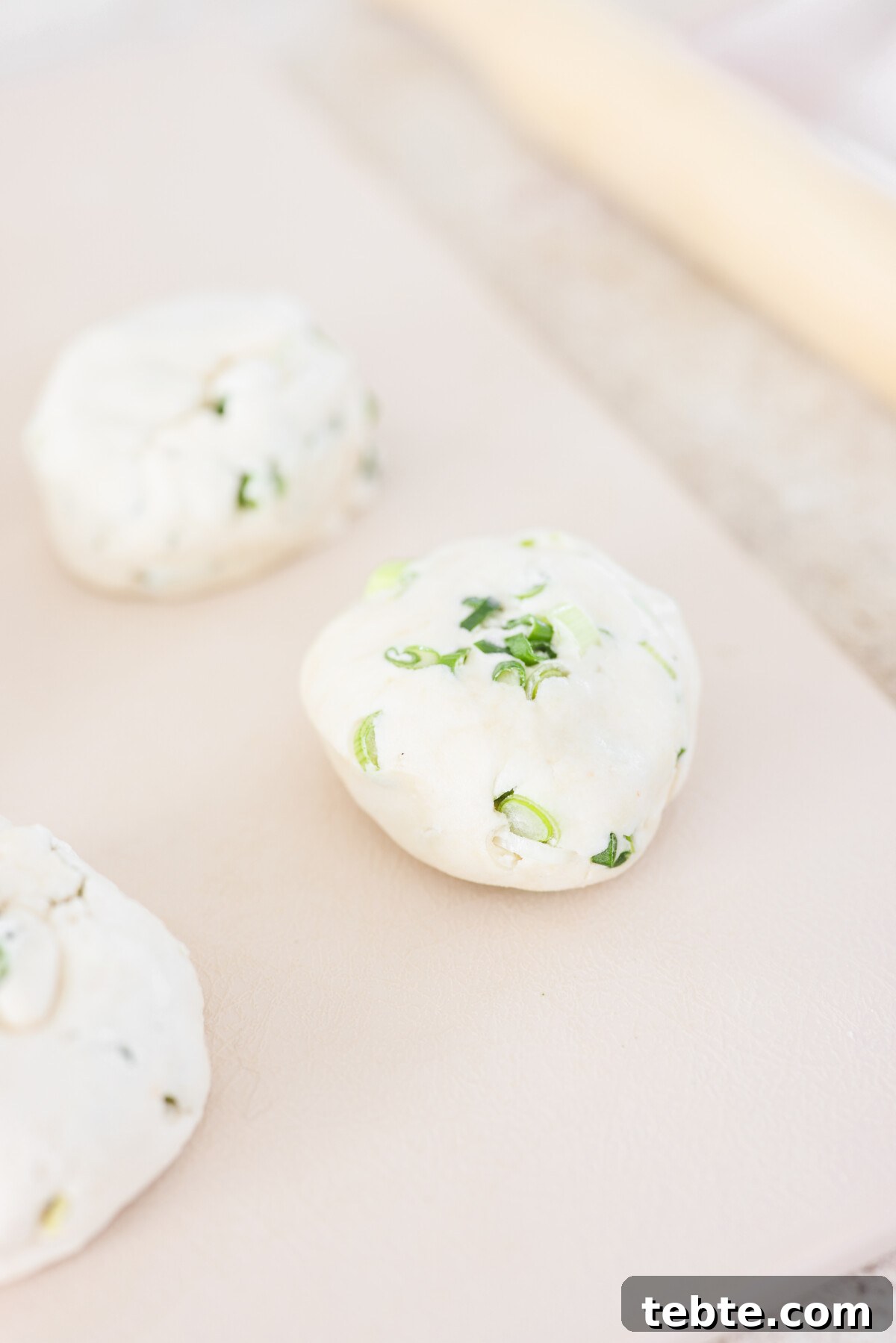 a ball of dough resting on parchment paper