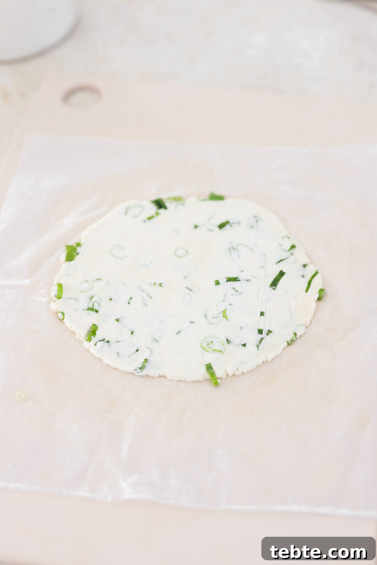a flatted dough pancake, uncooked. 