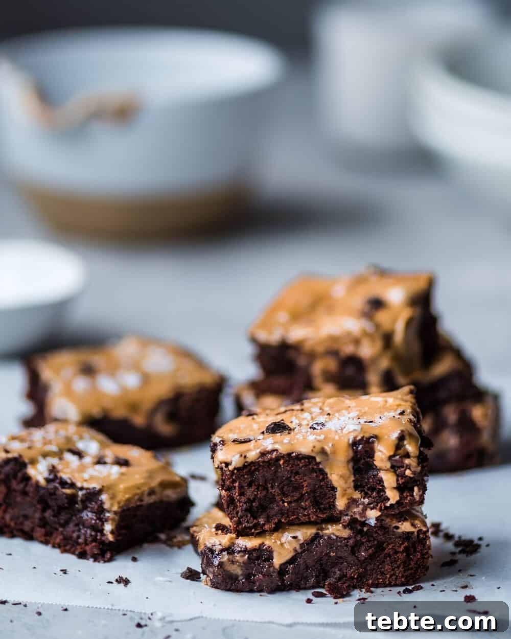 Vegan Gingerbread Brownies with Espresso Glaze Recipe 4 Brownies in stacks of two on parchment paper.