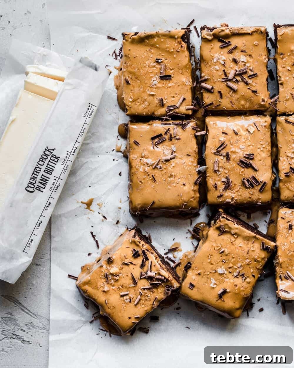 Vegan Gingerbread Brownies with Espresso Glaze Recipe 6 Gingerbread brownies next to a stick of vegan butter.