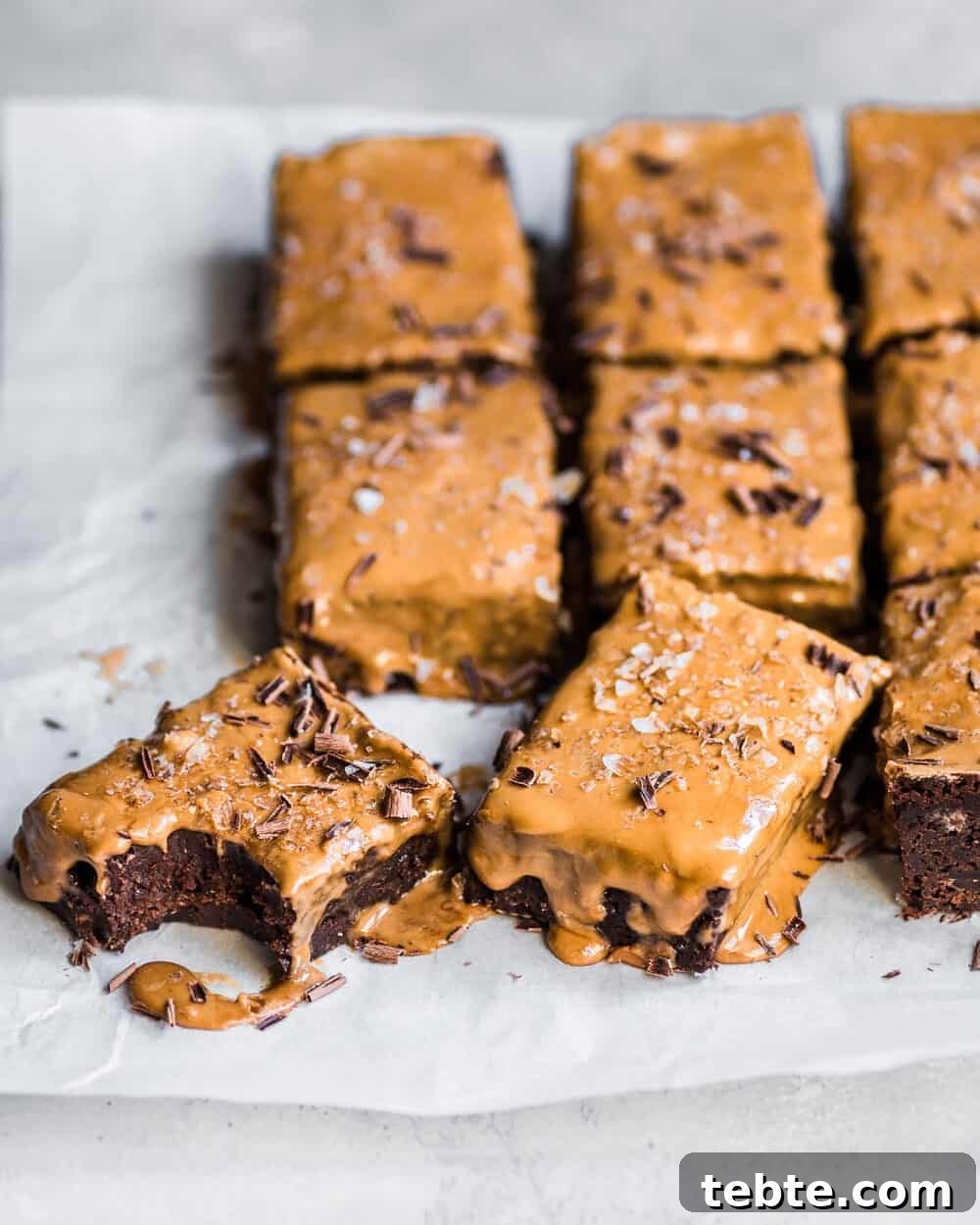 Vegan Gingerbread Brownies with Espresso Glaze Recipe 8 Gingerbread brownies on parchment paper.