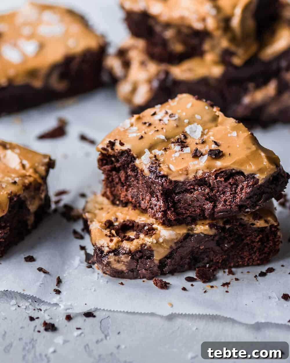 Vegan Gingerbread Brownies with Espresso Glaze Recipe 9 Two brownies stacked on parchment paper.