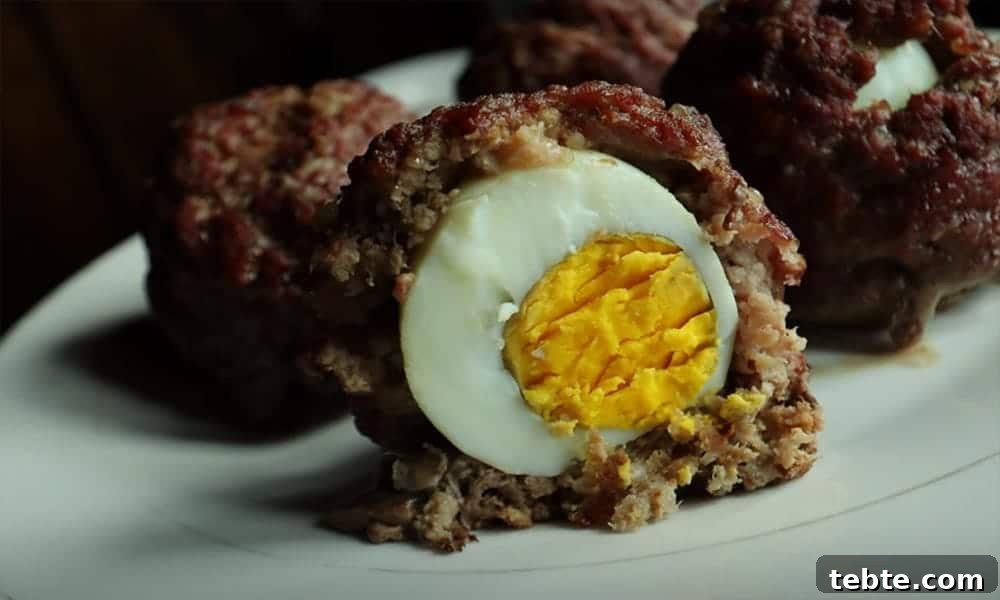 13 High-Protein Game Day Breakfasts to Fuel Your Morning 14 Scotch eggs with ground beef one cut in half.