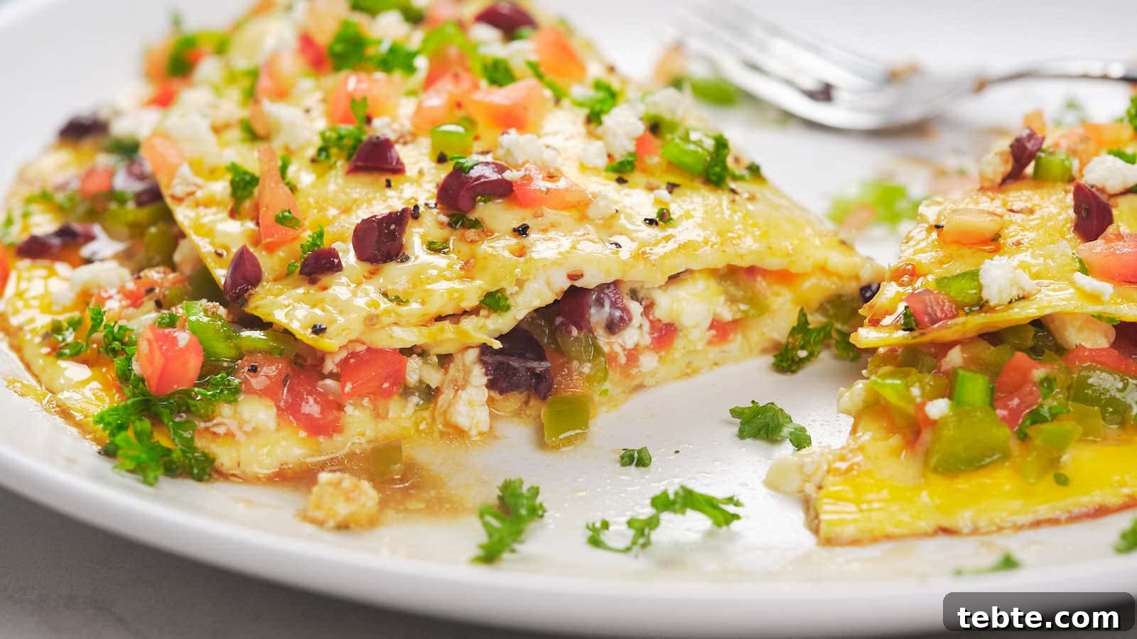 13 High-Protein Game Day Breakfasts to Fuel Your Morning 10 A plated serving of Mediterranean omelet filled with various ingredients.