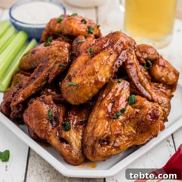 Savory Baked Cowboy Dip Recipe for Parties and Game Day 8 Closeup of finished glazed wings on a platter for the feature image.