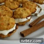 Cashew Carrot Bites with Honey Cream - Served on a Plate with Cinnamon Sticks