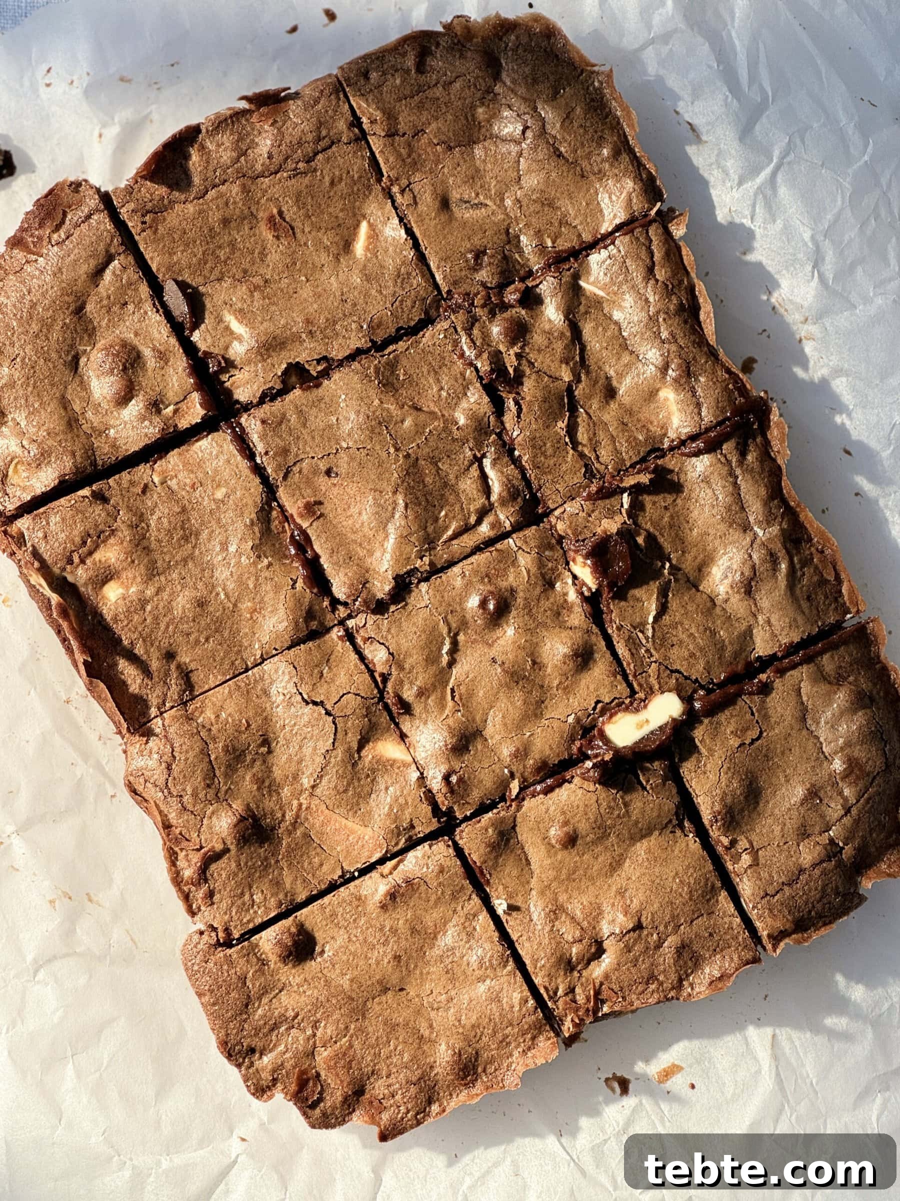 Double Chocolate Marble Brownies: Dark & White Swirl Recipe 10 overhead shot of sliced brownies on greaseproof paper.