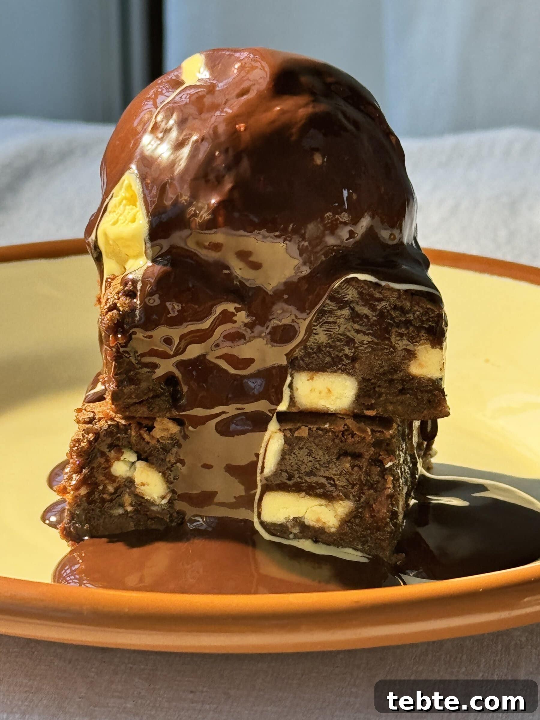 Double Chocolate Marble Brownies: Dark & White Swirl Recipe 11 chocolate and white chocolate brownies stacked with ice cream on top.