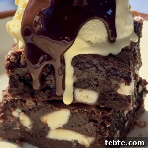 Double Chocolate Marble Brownies: Dark & White Swirl Recipe 16 chocolate and white chocolate brownies stacked with ice cream on top.