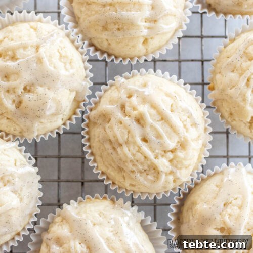 vanilla muffin recipe drizzled with vanilla bean glaze on cooling rack