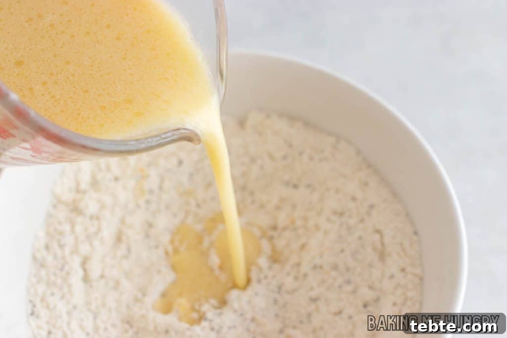 Citrus Poppy Seed Muffins with Orange Zest 6 wet ingredients added to bowl