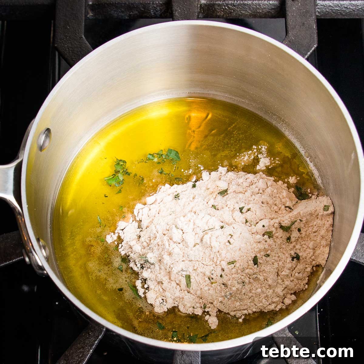 Creamy Vegan Mushroom Gravy Recipe 6 Small saucepan with olive oil, flour, herbs.