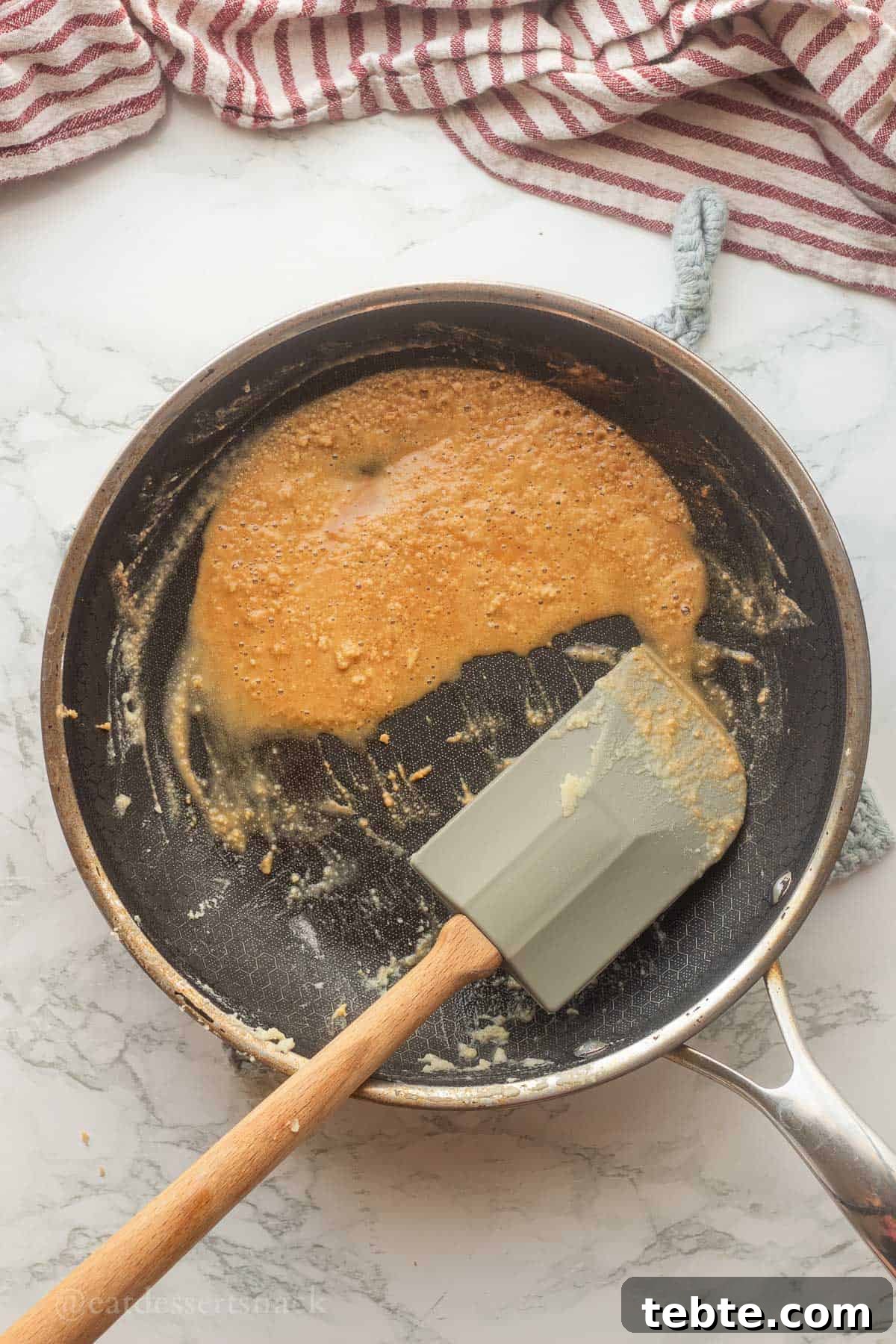 Homemade Brown Gravy Recipe for Roast and Mashed Potatoes 5 Brown butter and flour in metal pan with spatula.