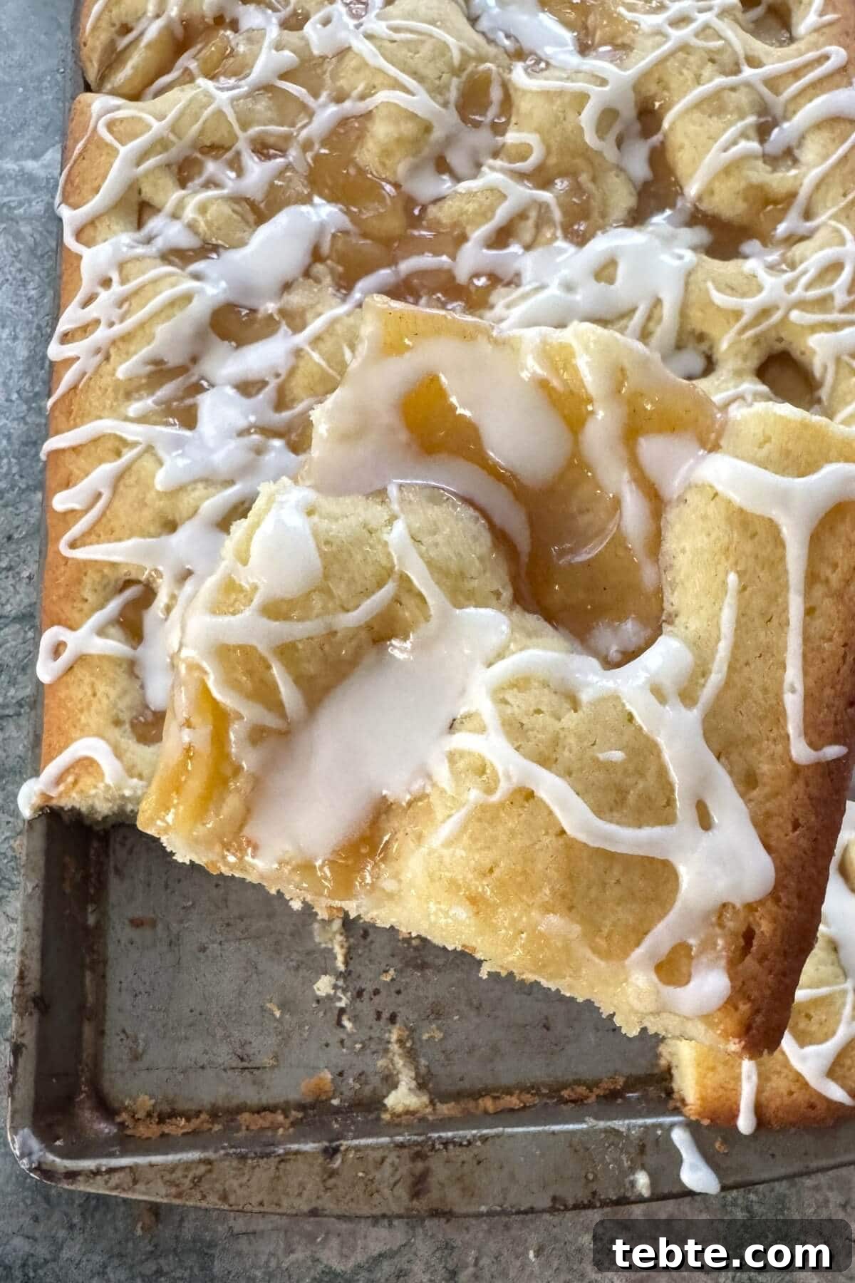 Sheet-Pan Scone Cake Recipe 2 A slice of apple scone cake on a spatula.