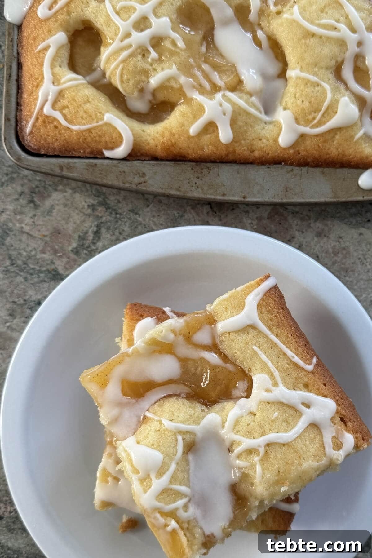 Sheet-Pan Scone Cake Recipe 3 Two slices of scone cake on a plate and the whole cake.