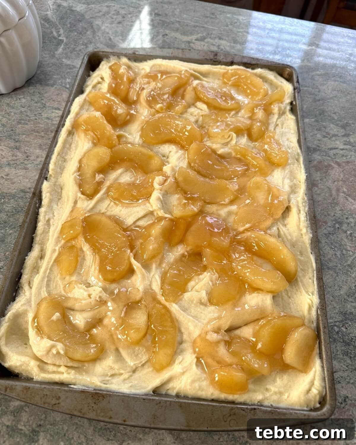 Sheet-Pan Scone Cake Recipe 8 An unbaked sheet pan breakfast cake with apple pie filling.