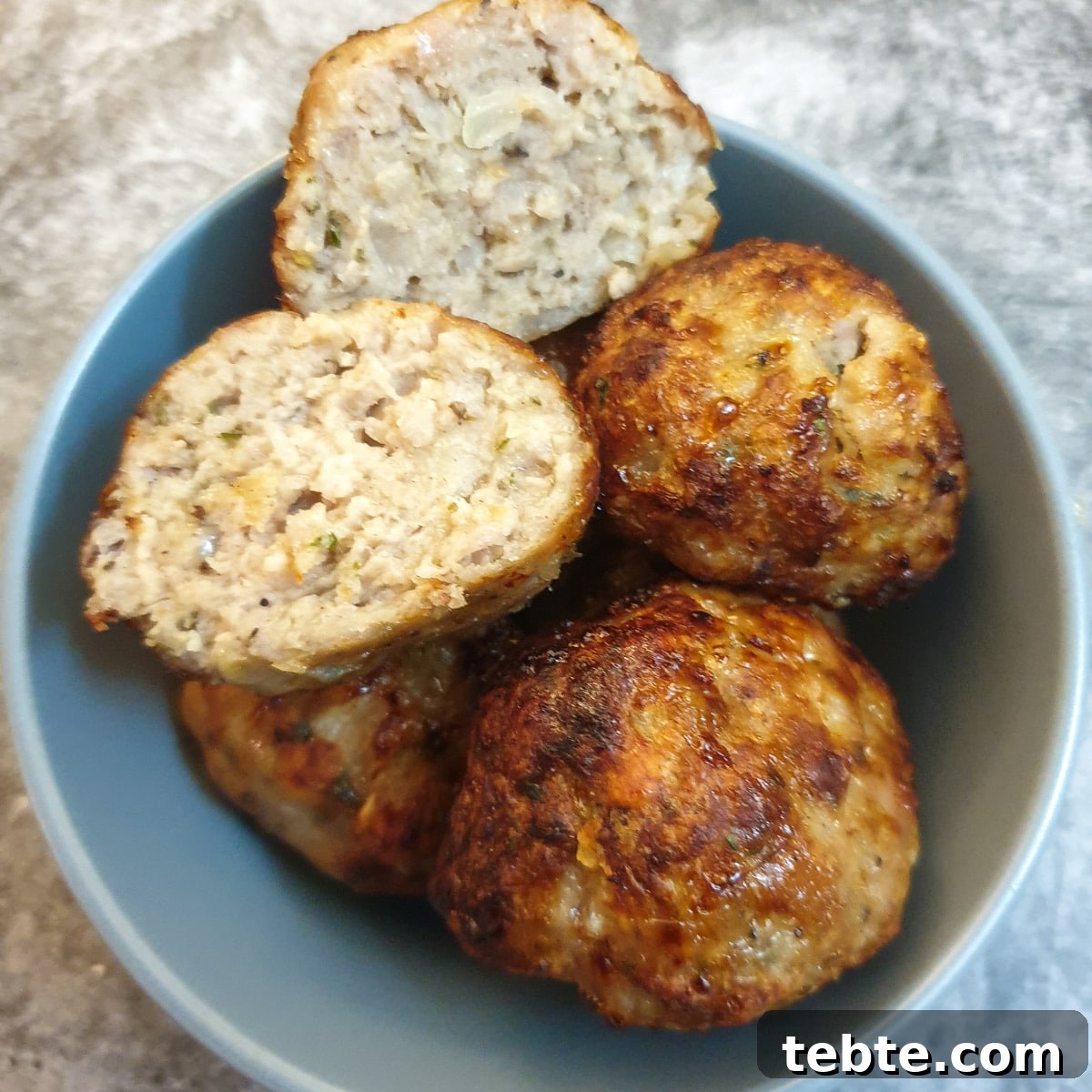 Sausage Stuffing with Sage and Onion 12 sage and onion pork stuffing balls in dish.