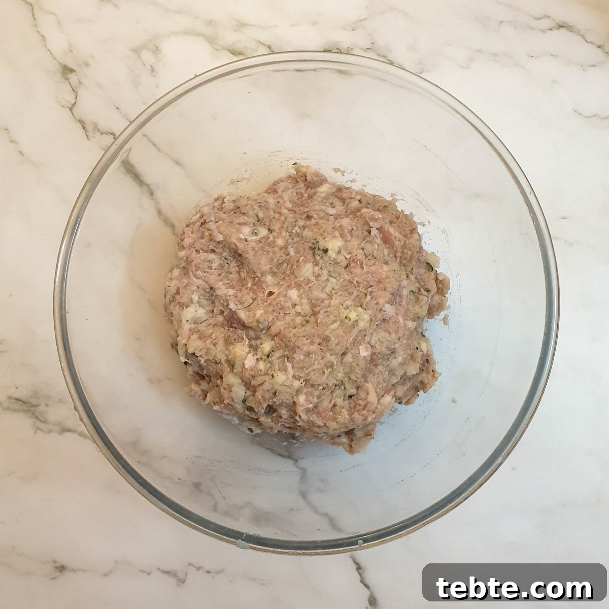 Sausage Stuffing with Sage and Onion 6 Sage and onion stuffing mixed in a glass bowl.