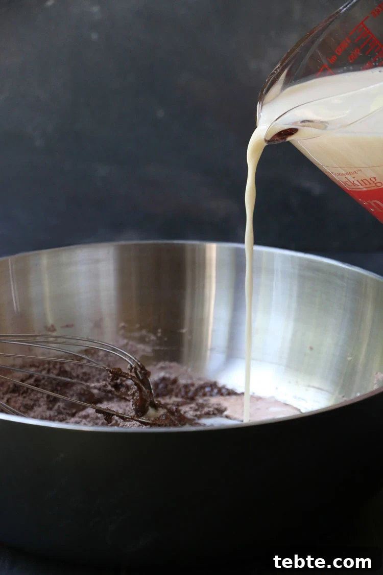 Classic Chocolate Cream Pie Made from Scratch 7 Pouring milk into chocolate pudding mixture