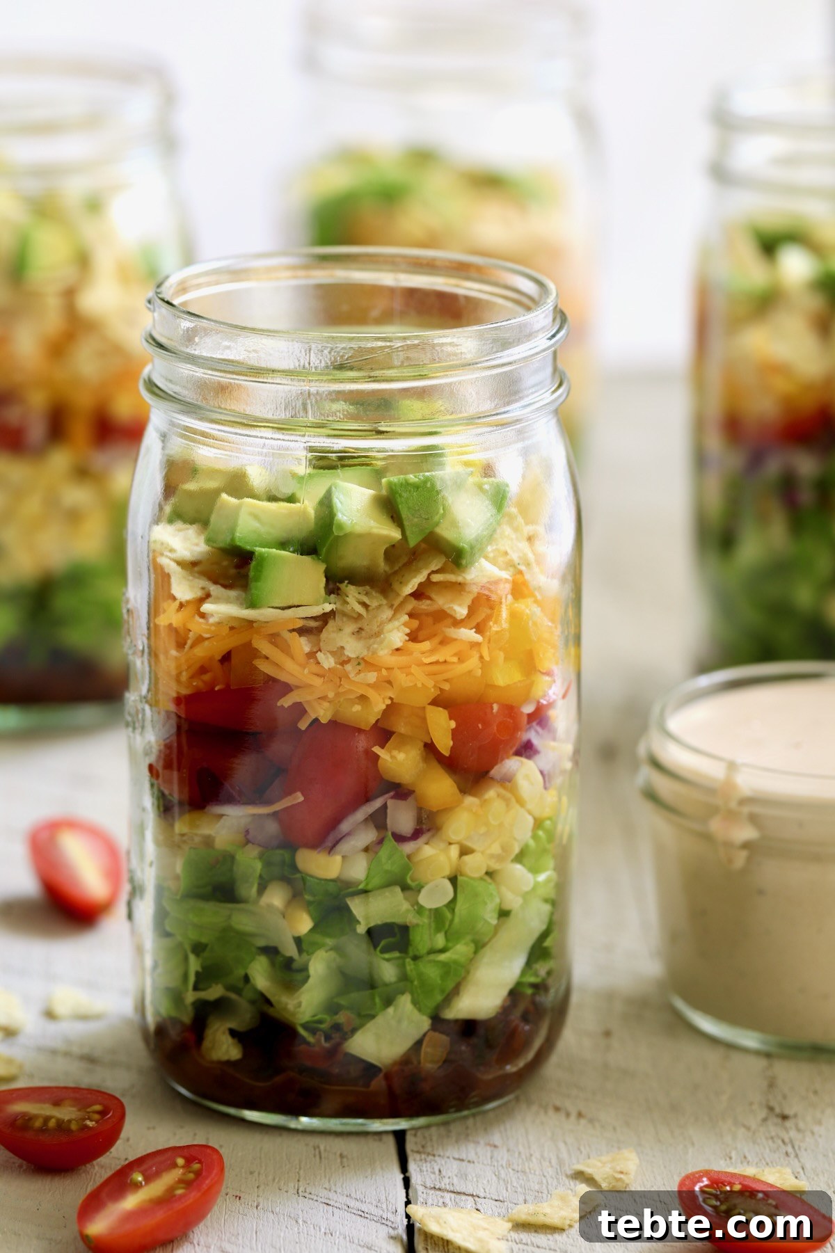 Layered Southwestern Salad with Corn, Black Beans, and Avocado 9 Southwestern Layered Salad in glass Mason jar.