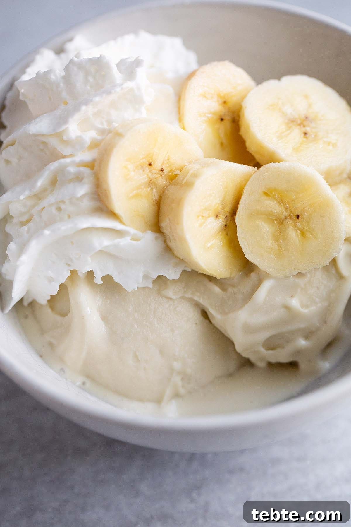 Banana Cream Pie Ice Cream Recipe for Ninja Creami 2 Ninja Creami banana cream pie ice cream topped with sliced bananas and whipped cream