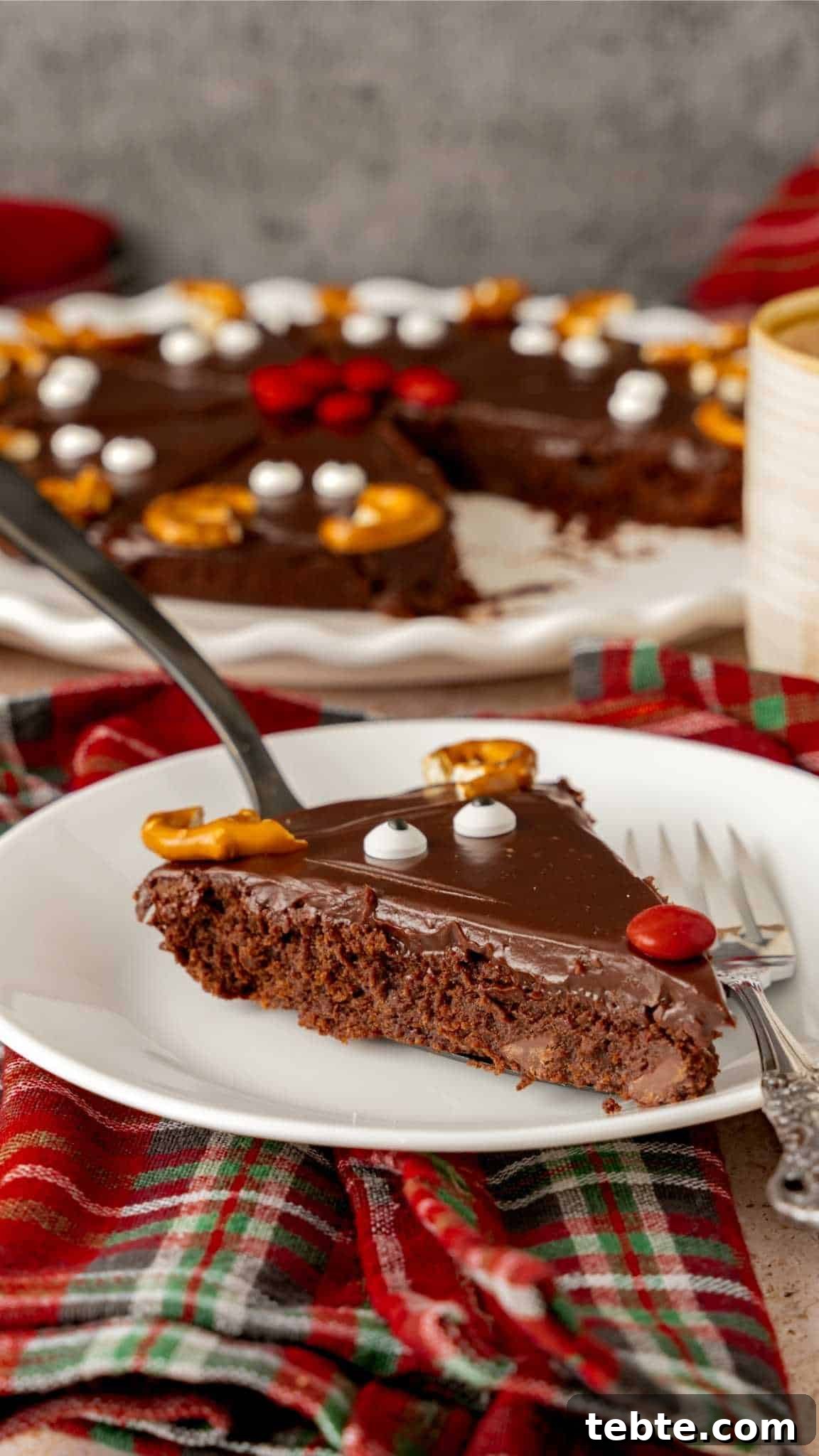 Reindeer Christmas Brownies Recipe for Festive Treats 3 A Rudolf Reindeer Brownie glazed with chocolate ganache with a face on a white saucer.
