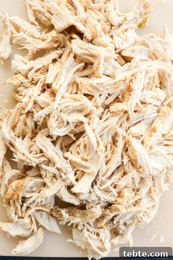 Creamy White Chicken Chili in the Slow Cooker 6 shredded chicken on a cutting board