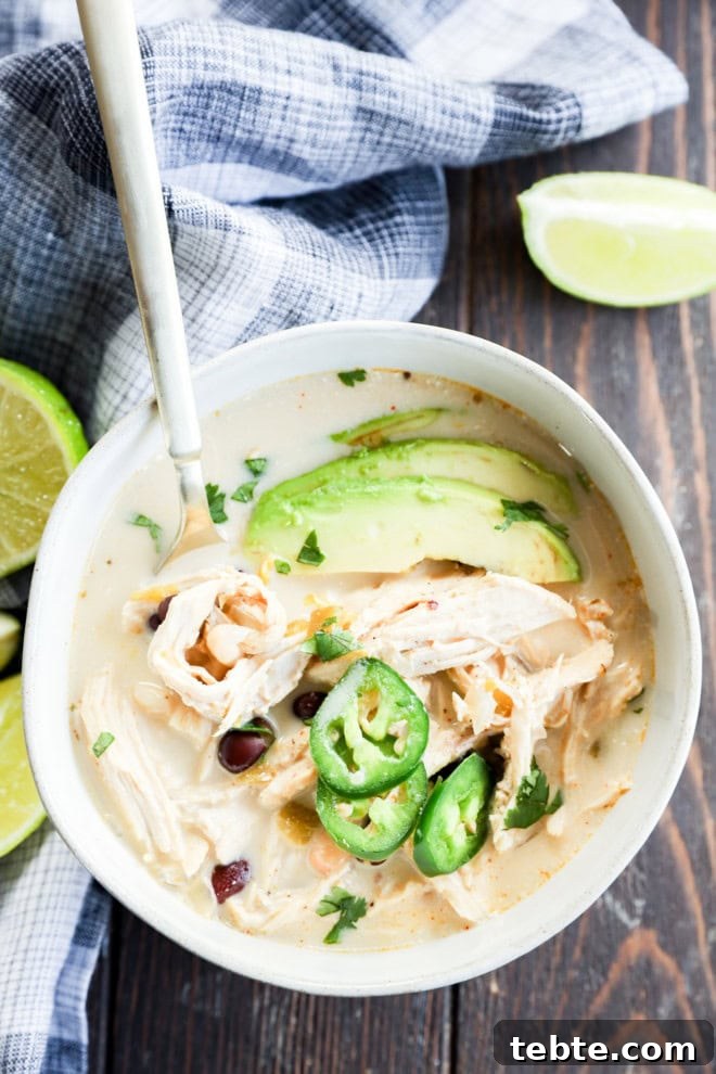 Creamy White Chicken Chili in the Slow Cooker 9 Bowl of Slow cooker creamy white chicken chili with spoon in it