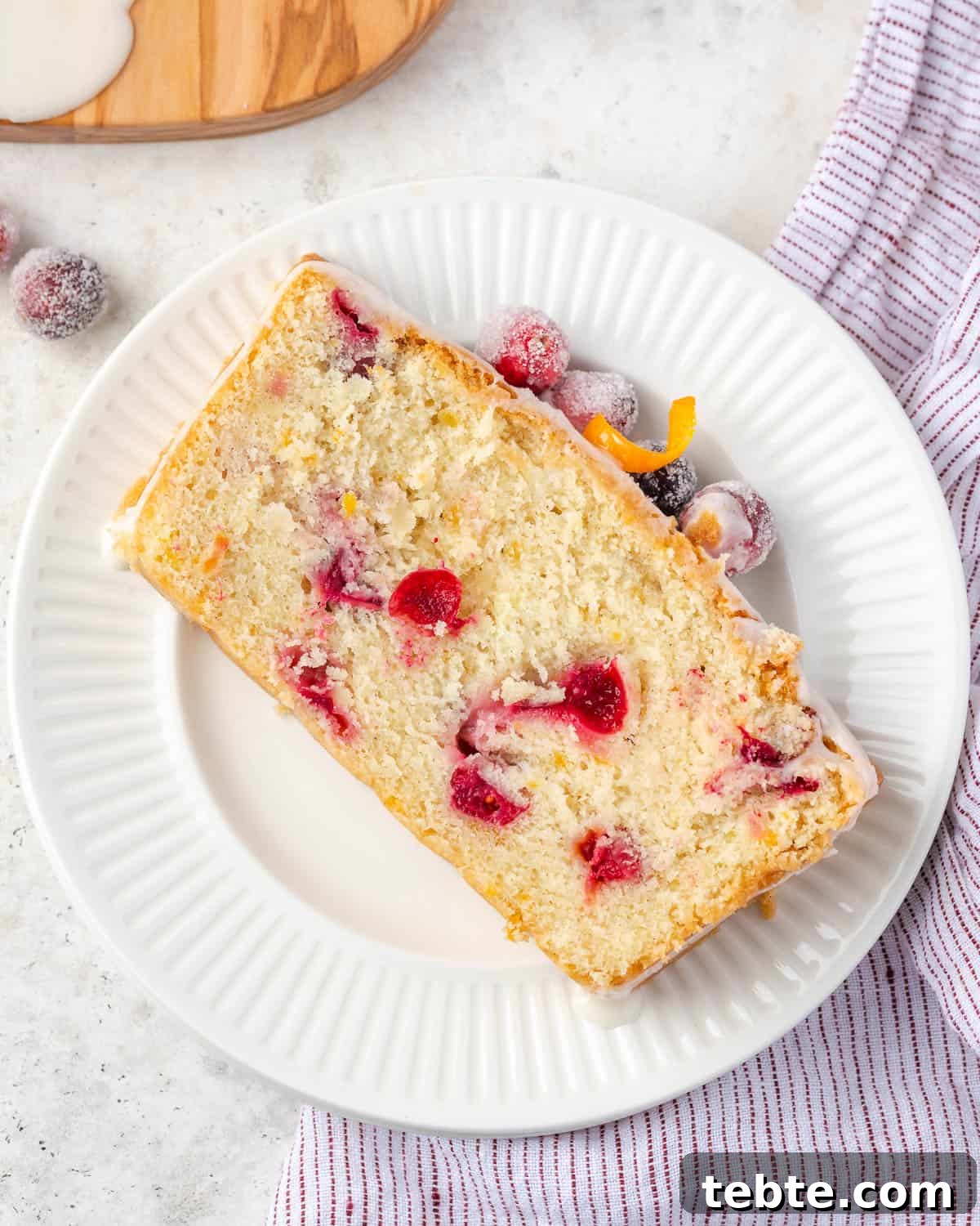 Classic Cranberry Orange Pound Cake Recipe 13 A slice of cranberry orange pound cake served on a small dessert plate.