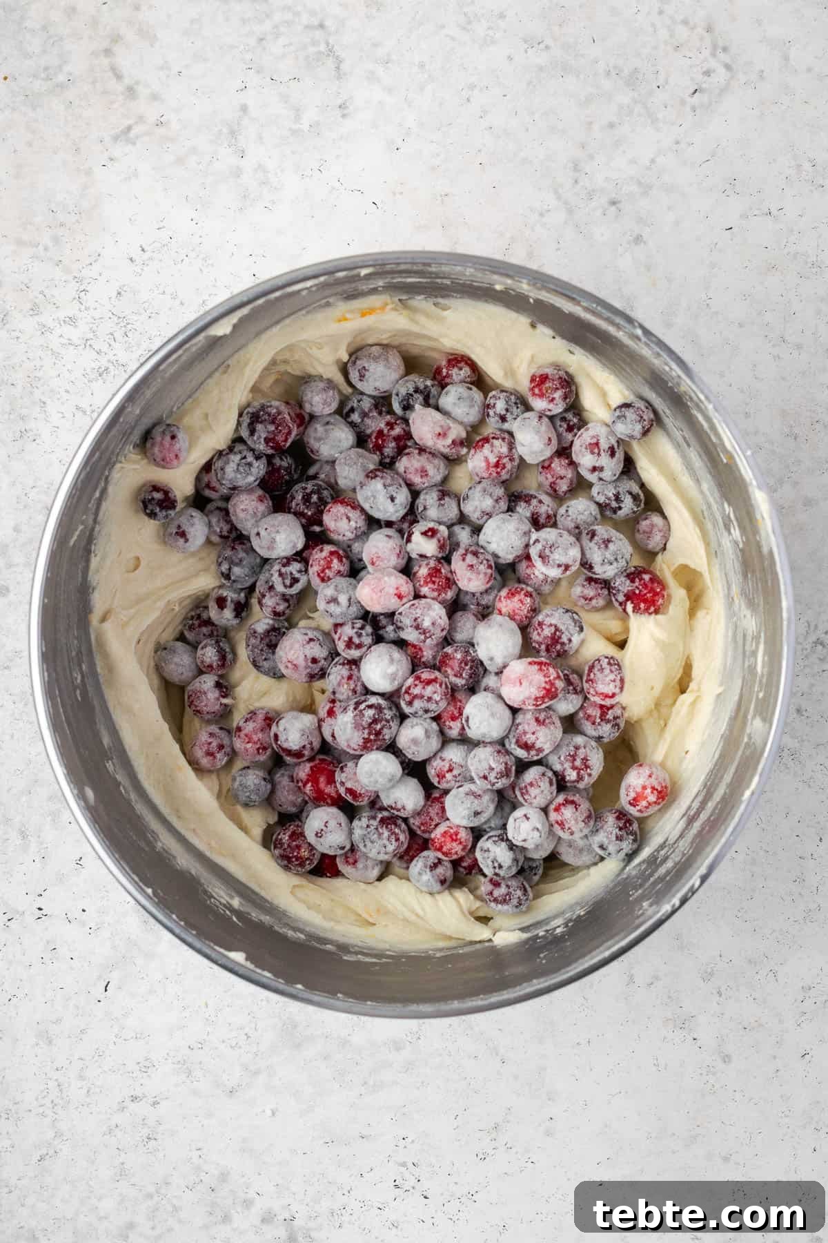 Classic Cranberry Orange Pound Cake Recipe 10 Flour coated cranberries added to the mixing bowl with the cake batter.