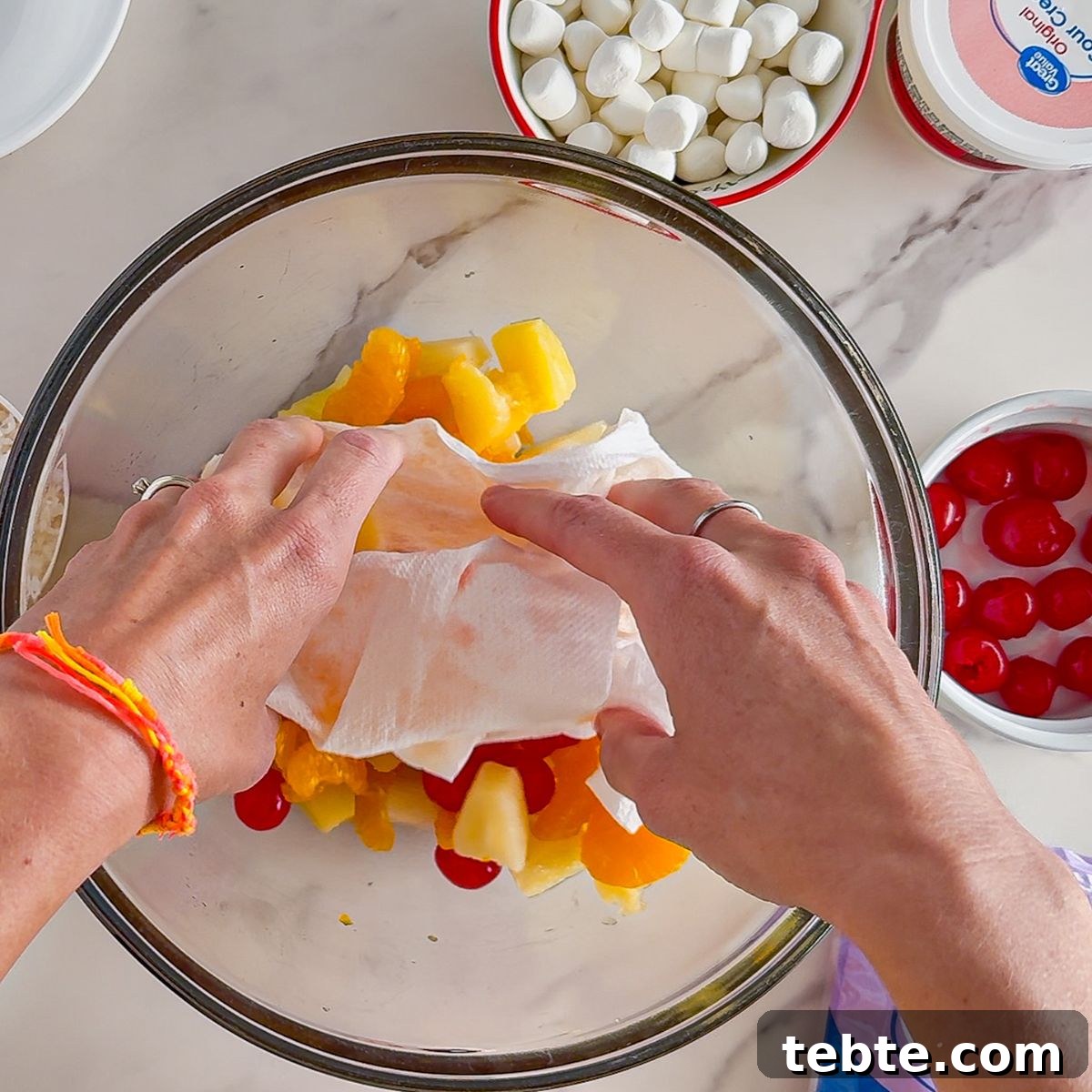 Classic Ambrosia Salad Recipe with Citrus and Coconut 4 Adding softened cream cheese to ambrosia salad.