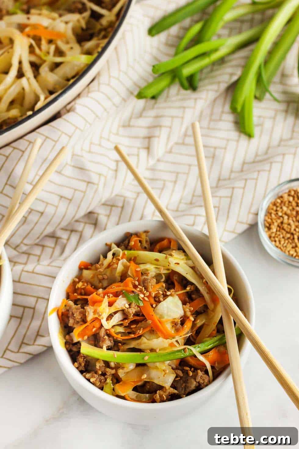 Keto Egg Roll in a Bowl: Low-Carb One-Pan Recipe 2 keto egg roll in a bowl with chopsticks sitting on the bowl