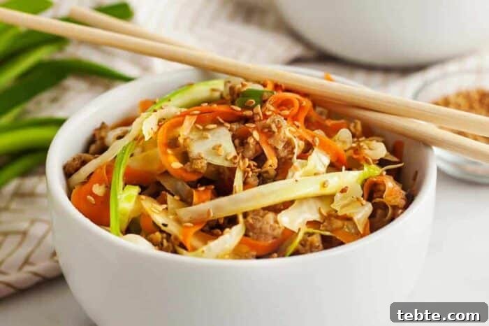 Keto Egg Roll in a Bowl: Low-Carb One-Pan Recipe 5 keto egg roll in a bowl closeup view with chopsticks sitting on top