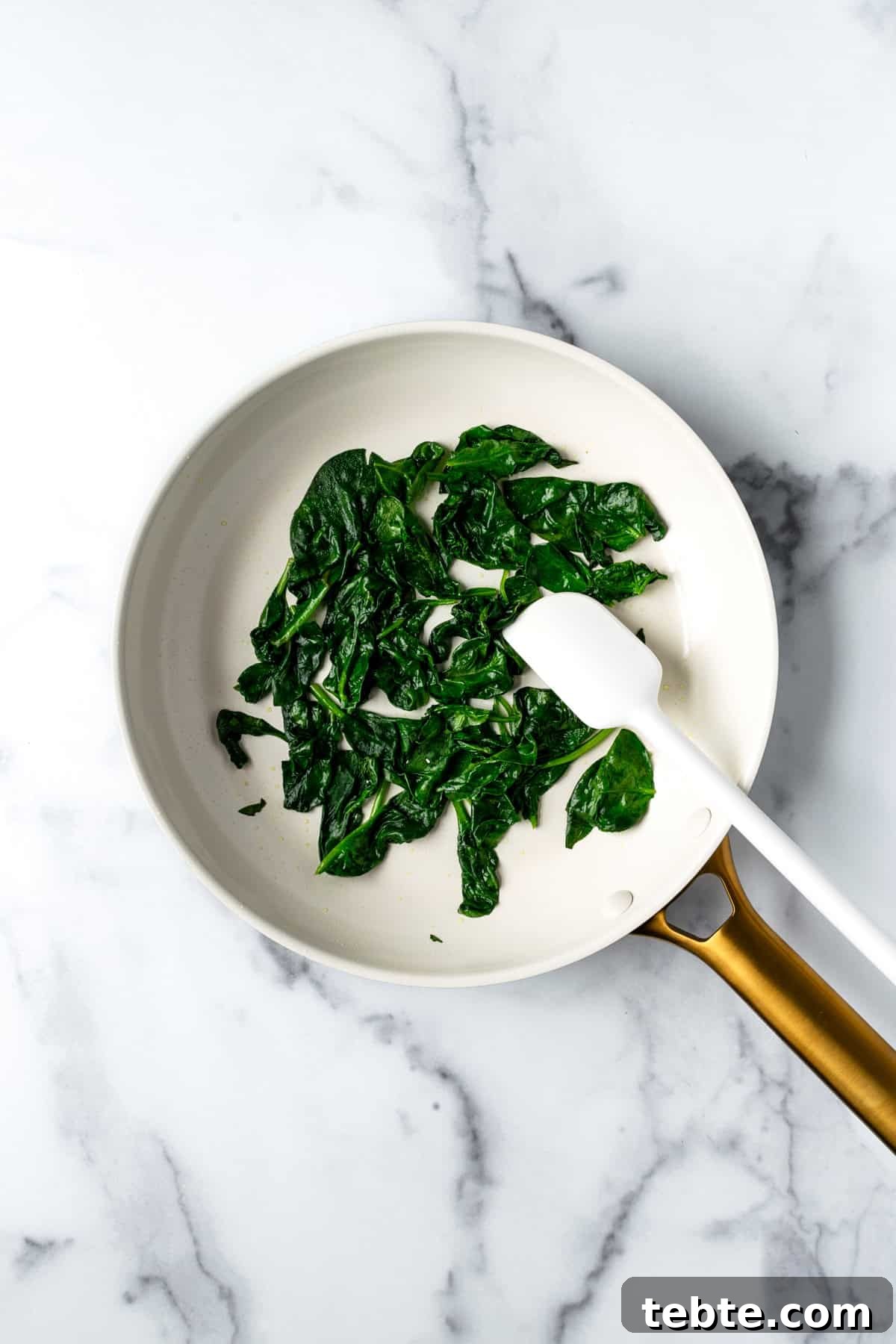 Crispy Roasted Cauliflower Bowl Recipes 5 Sautéed Spinach in a White Skillet.