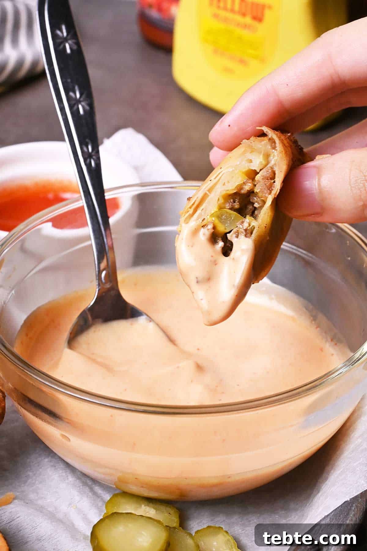 How to Make Crispy Cheeseburger Spring Rolls 6 cheeseburger spring rolls dipped in sauce